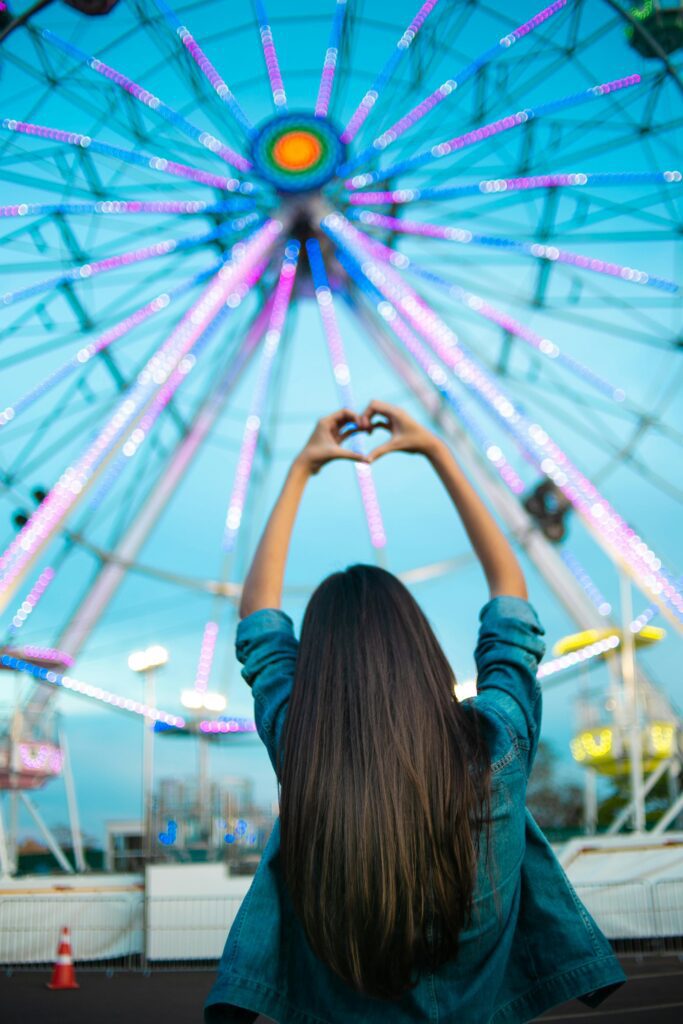 Ferris Wheel and woman signing heart