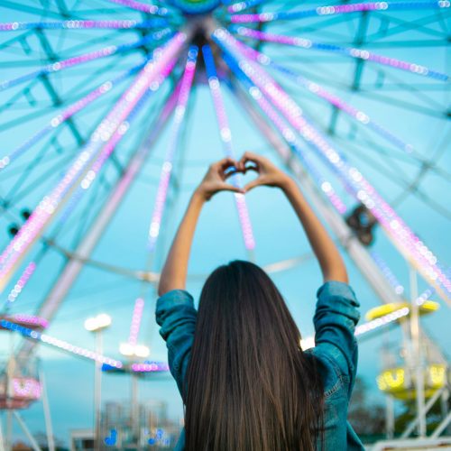 Ferris Wheel and woman signing heart